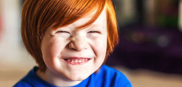 Boy with ginger hair grinning