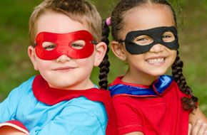 Two small children wearing superhero masks