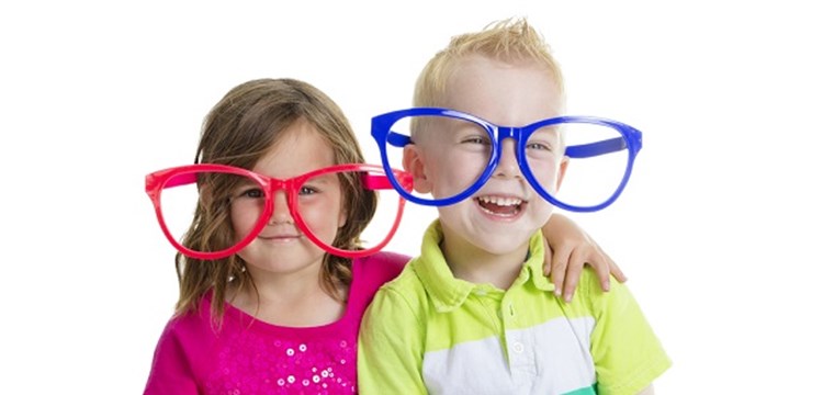young boy and child wearing red and blue comedy glasses