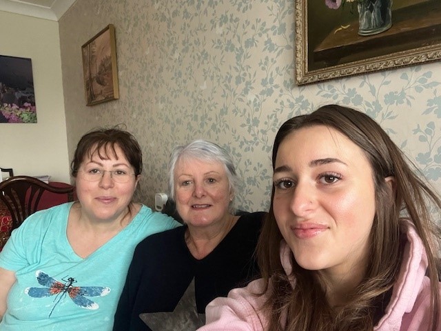 Three women - Albana, Sue and Chiara - sitting on a sofa 