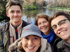 Ruth, a foster carer, and her family taking a selfie in front of a pond