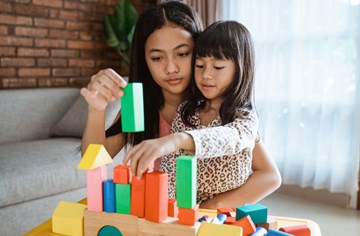 A lady and child building blocks